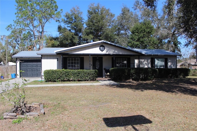 single story home featuring a garage and a front yard