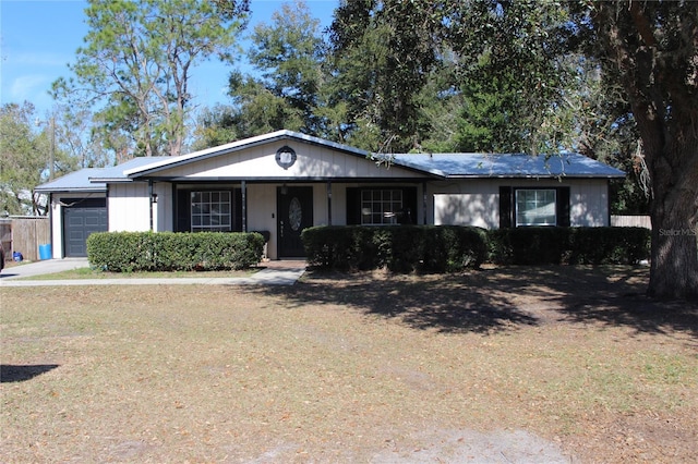 single story home featuring a garage and a front yard