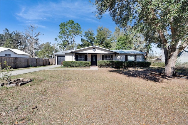 ranch-style house featuring a garage and a front yard