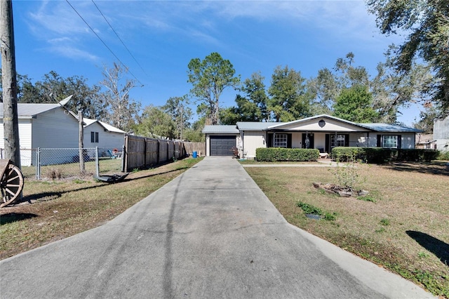 view of front facade with a garage and a front lawn