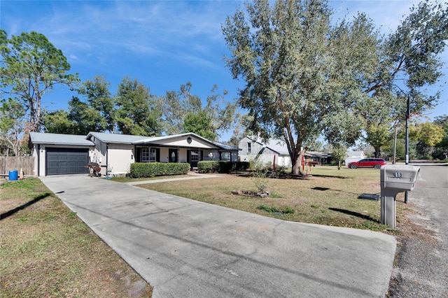 ranch-style home featuring a garage and a front lawn