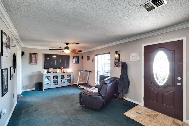 foyer with crown molding, carpet floors, and a textured ceiling