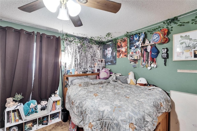 bedroom featuring ceiling fan, carpet, and a textured ceiling