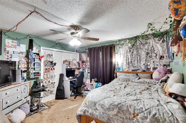 carpeted bedroom with ceiling fan and a textured ceiling