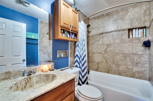 full bathroom with vanity, shower / bath combo with shower curtain, a textured ceiling, and toilet