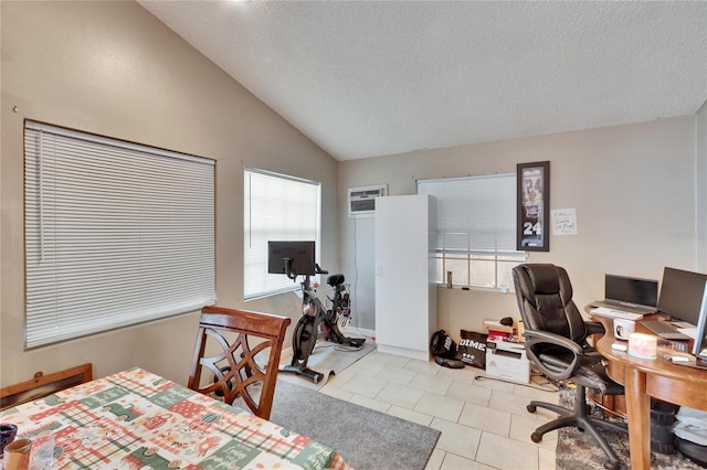 tiled home office featuring vaulted ceiling and a textured ceiling