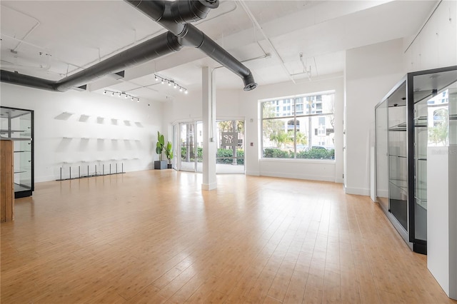 interior space with track lighting and light hardwood / wood-style floors