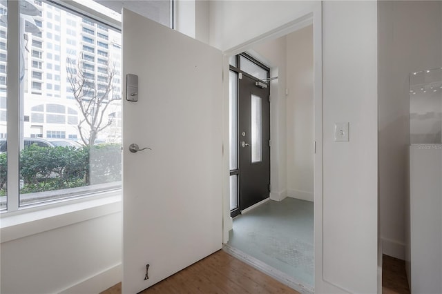 hall with hardwood / wood-style flooring