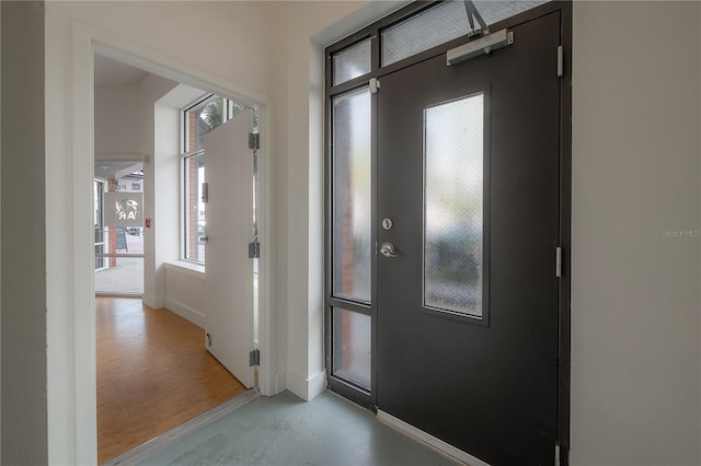 foyer with a wealth of natural light and concrete floors