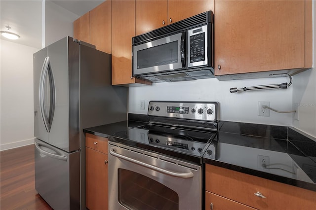 kitchen featuring dark hardwood / wood-style flooring and appliances with stainless steel finishes