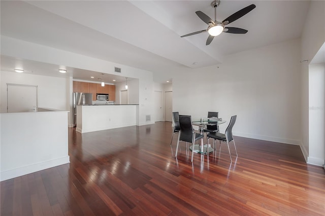 dining space featuring ceiling fan and dark hardwood / wood-style flooring