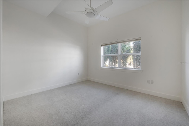 spare room featuring light colored carpet and ceiling fan