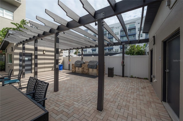 view of patio / terrace with a grill, area for grilling, and a pergola