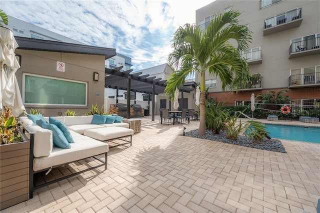 view of patio with an outdoor hangout area, a community pool, and a pergola