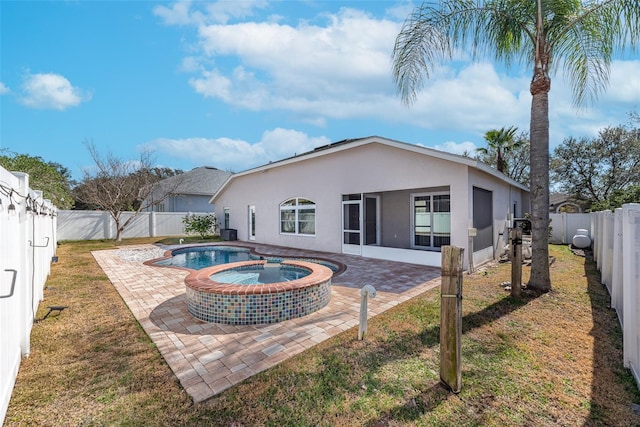 view of swimming pool with a patio area, a lawn, and an in ground hot tub