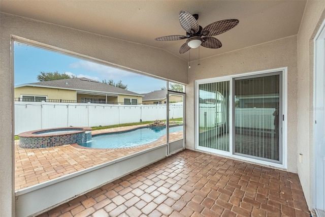 view of pool featuring a patio area, ceiling fan, and an in ground hot tub