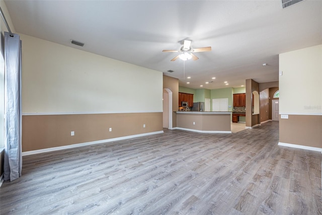 unfurnished living room featuring light hardwood / wood-style floors and ceiling fan