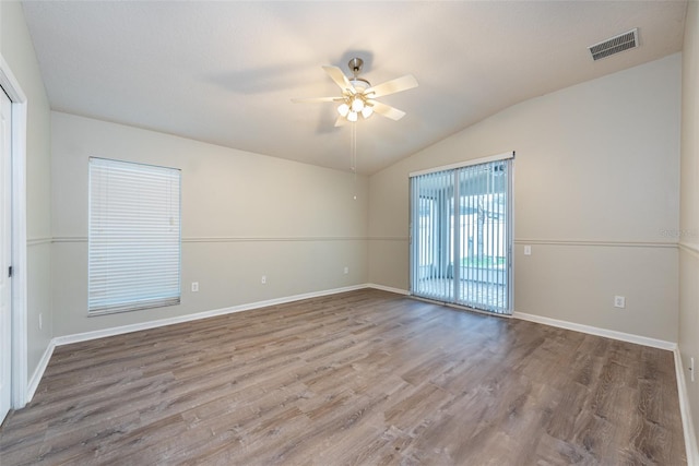 unfurnished room with ceiling fan, lofted ceiling, and hardwood / wood-style floors