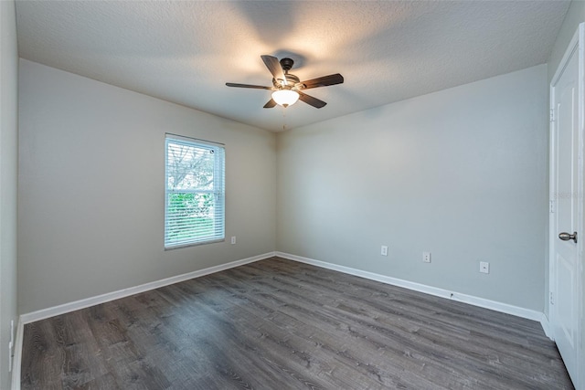 spare room with dark hardwood / wood-style flooring, a textured ceiling, and ceiling fan