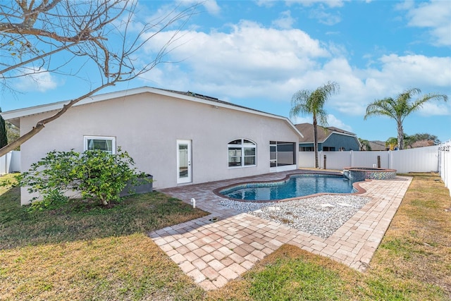 view of swimming pool with an in ground hot tub, a patio area, and a lawn