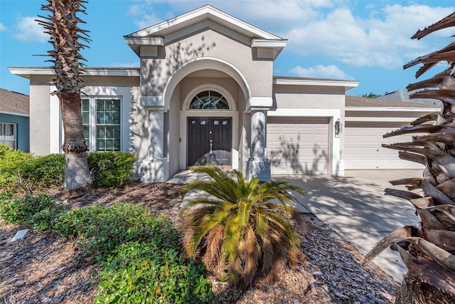 view of front of property with french doors and a garage