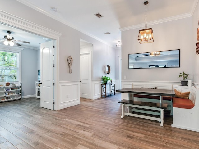 interior space with an inviting chandelier, ornamental molding, and hardwood / wood-style floors