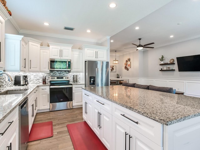 kitchen featuring sink, stainless steel appliances, and white cabinets