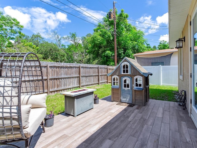 wooden deck with an outdoor fire pit