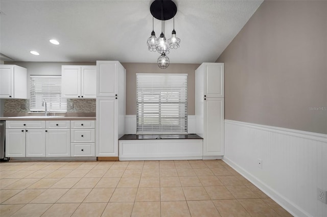 kitchen featuring white cabinetry, sink, and a healthy amount of sunlight