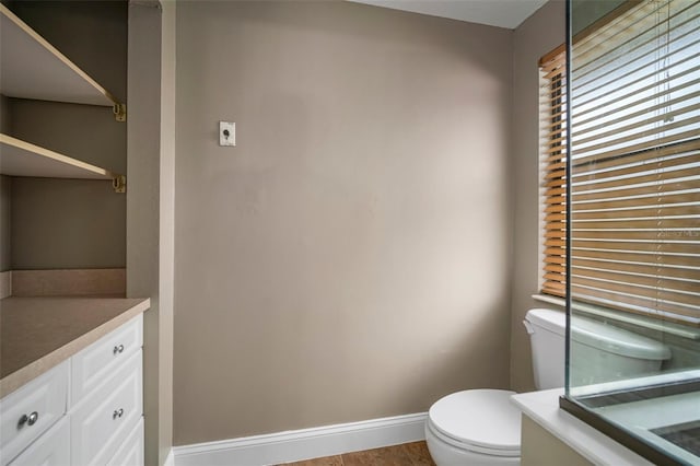 bathroom with vanity, toilet, and wood-type flooring