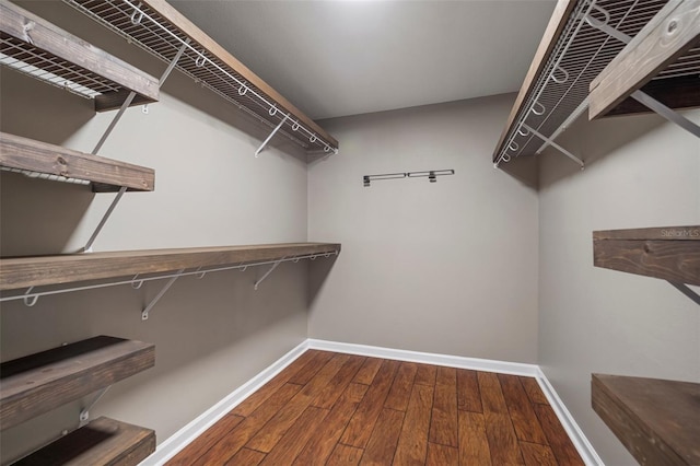 walk in closet with wood-type flooring