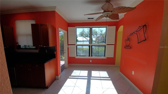 interior space with crown molding and ceiling fan