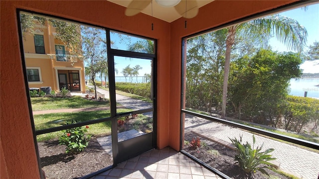 sunroom / solarium with a wealth of natural light and a water view