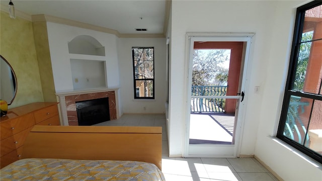 tiled bedroom with crown molding and a high end fireplace