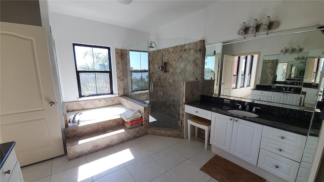 bathroom featuring vanity, independent shower and bath, and tile patterned flooring