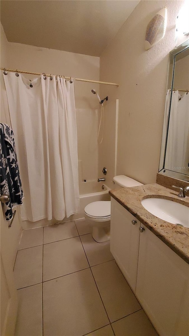 full bathroom with shower / bath combination with curtain, vanity, tile patterned floors, and toilet