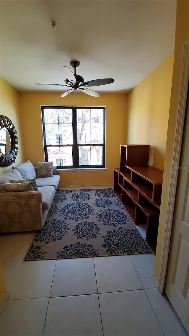 tiled living room featuring ceiling fan