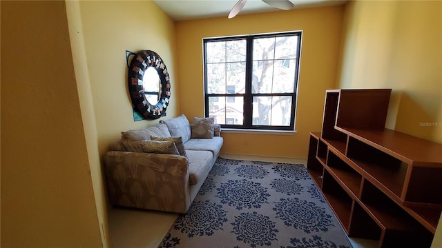 living area with a wealth of natural light and ceiling fan