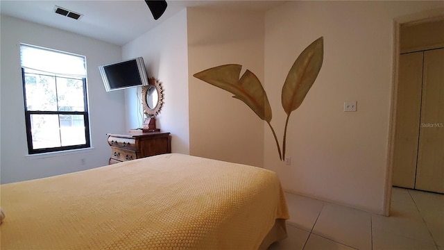 tiled bedroom with ceiling fan