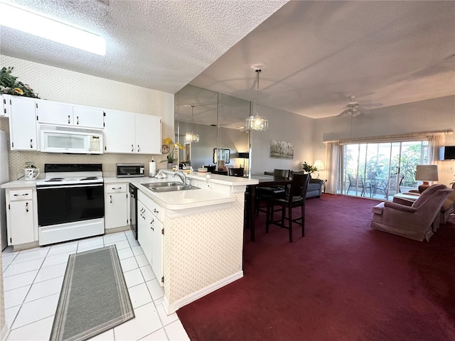 kitchen with sink, white cabinetry, hanging light fixtures, kitchen peninsula, and white appliances