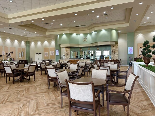 2116 Nantucket Dr Unit 19, Sun City Center, FL 33573 - dining area featuring a high ceiling, a tray ceiling, visible vents, and recessed lighting