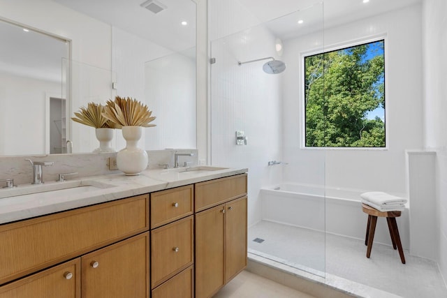 bathroom with shower with separate bathtub, tile patterned floors, and vanity