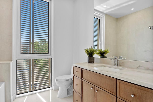 bathroom featuring tile patterned floors, toilet, and vanity