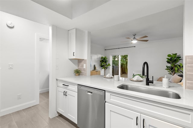 kitchen featuring sink, dishwasher, ceiling fan, white cabinetry, and ornamental molding