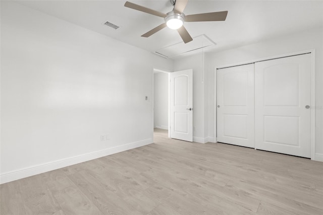 unfurnished bedroom with light hardwood / wood-style flooring, ceiling fan, and a closet