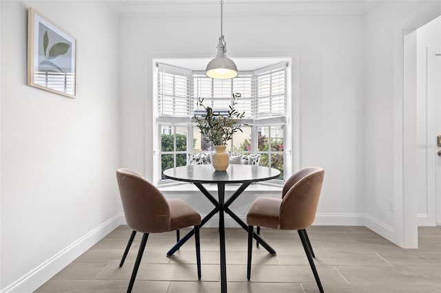 dining area with crown molding and breakfast area