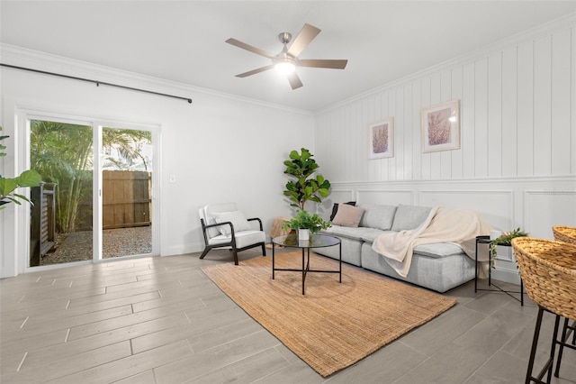 living room featuring crown molding and ceiling fan