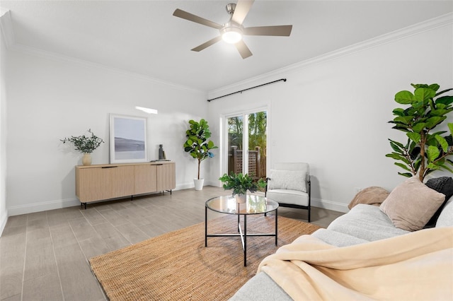 living room featuring ornamental molding, ceiling fan, and light hardwood / wood-style flooring