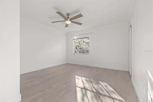 unfurnished room with ornamental molding, ceiling fan, and light hardwood / wood-style flooring