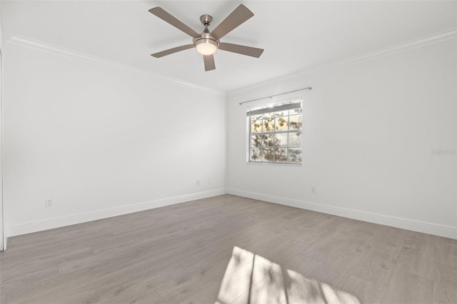 spare room featuring crown molding, light hardwood / wood-style floors, and ceiling fan